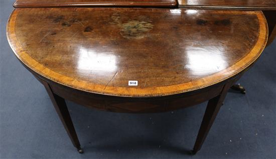 A George III mahogany demi-lune folding dining table W.132cm